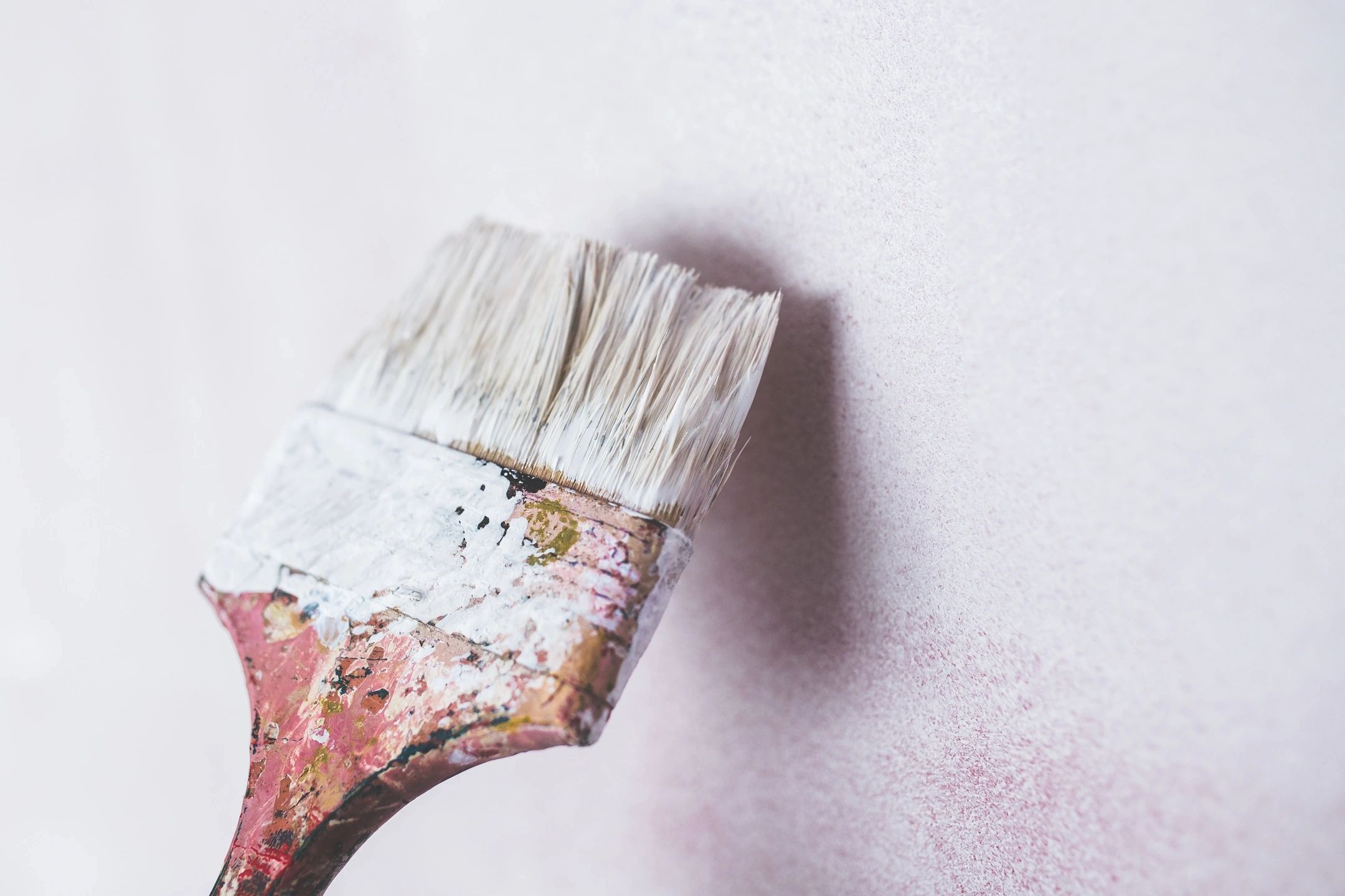 Close-up of a paintbrush with dried paint — craftsmanship detail